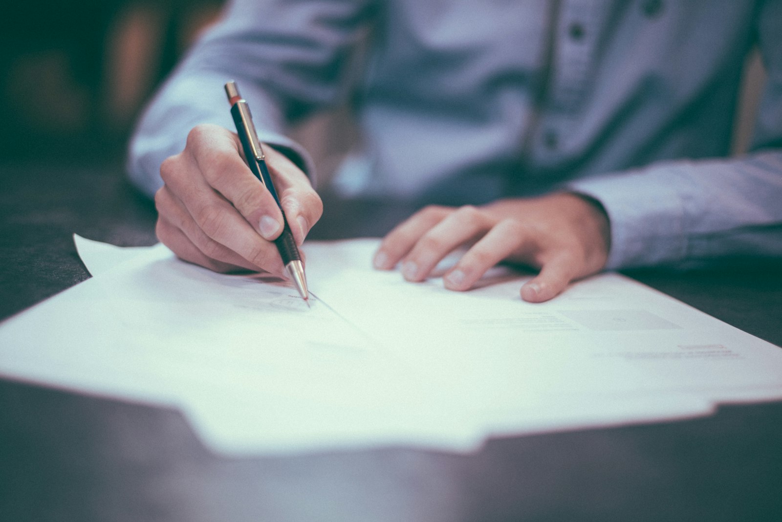 An executed commercial contract on the desk of a general counsel with the cover page visible